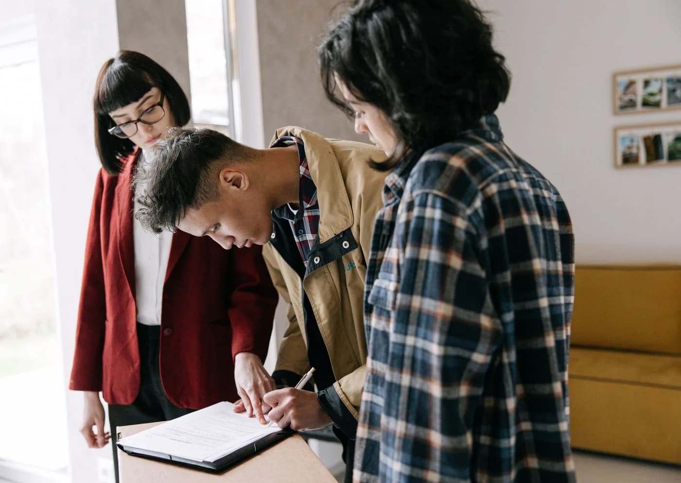 Real estate clients reviewing documents with an agent at a table