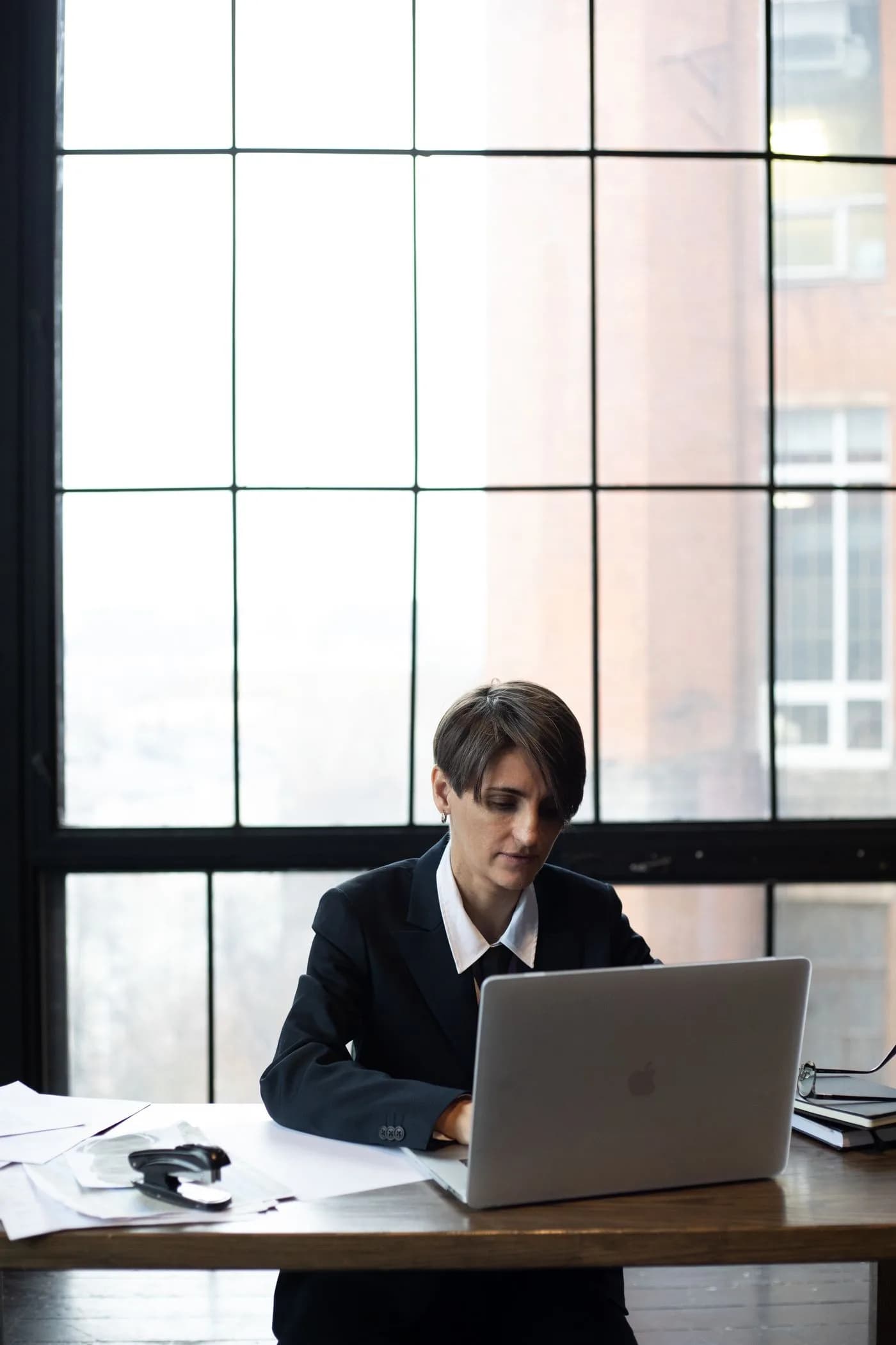 Professional working on a laptop in a bright office