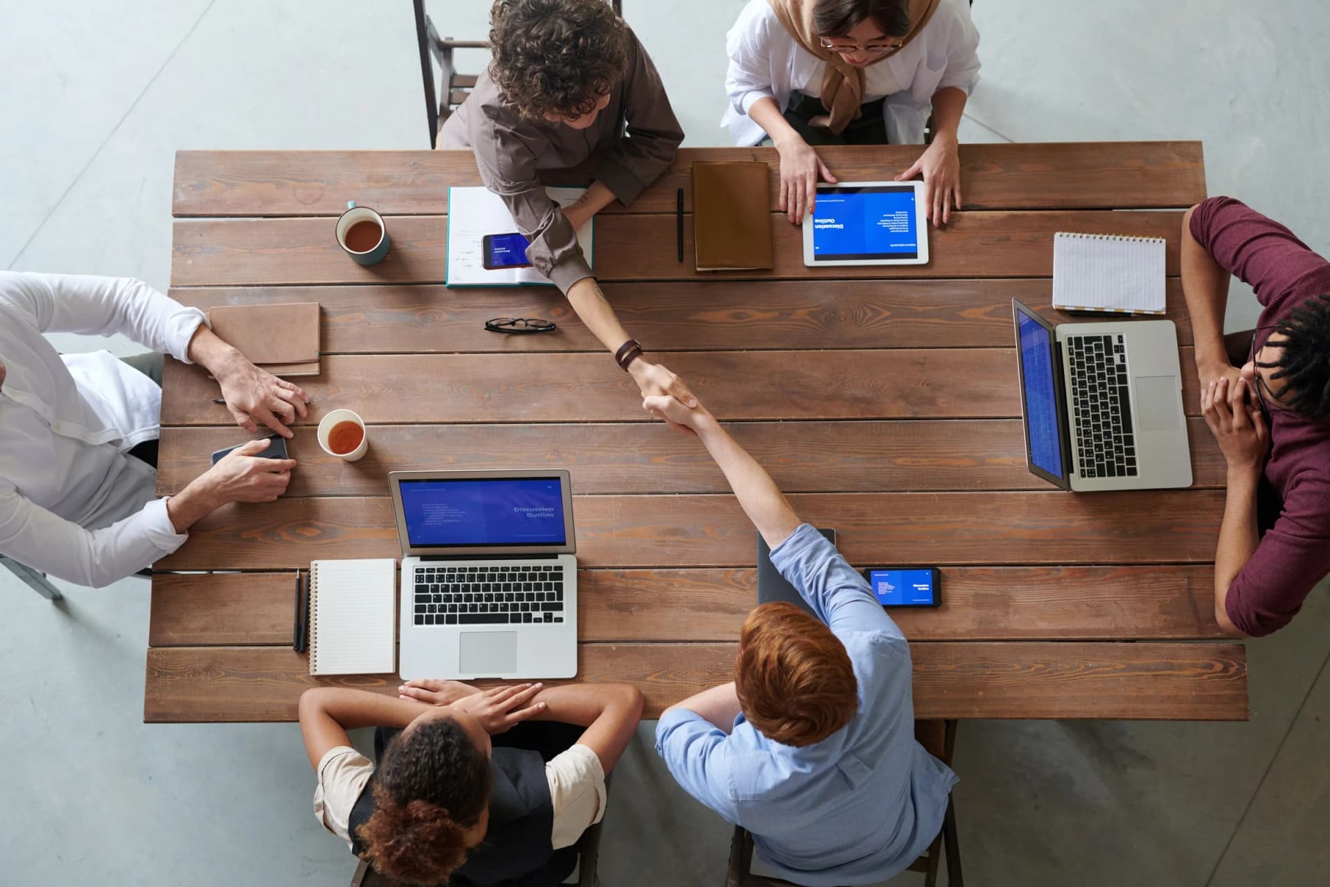 Colleagues coordinating work around a meeting table
