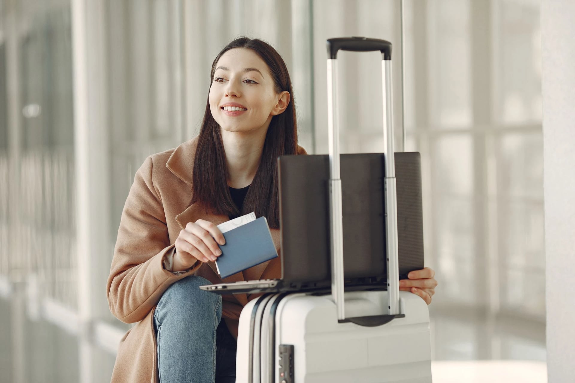 Traveller seated with luggage and travel documents