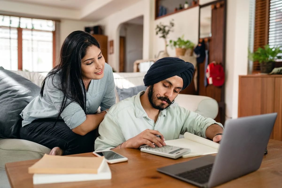 Two people discussing plans in a home